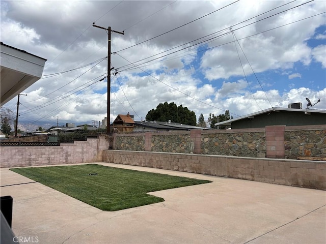 view of yard with a patio area and a fenced backyard