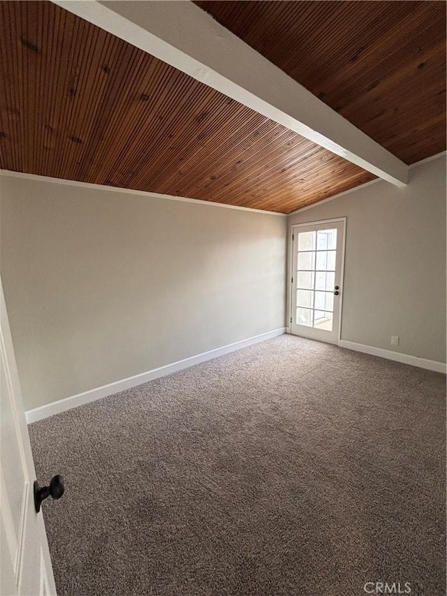 empty room featuring lofted ceiling with beams, wooden ceiling, baseboards, and carpet flooring