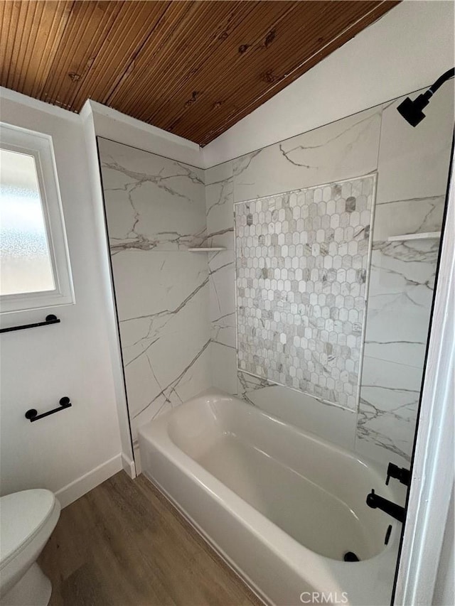 bathroom with wood ceiling, shower / washtub combination, wood finished floors, and toilet