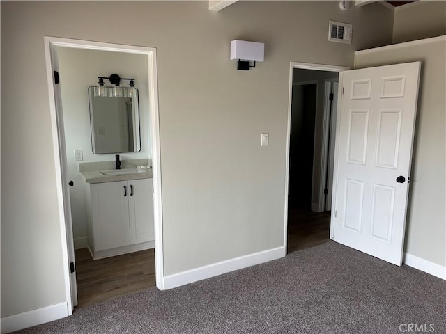 unfurnished bedroom featuring carpet, visible vents, and baseboards