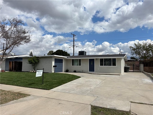 ranch-style house with an attached garage, fence, concrete driveway, stucco siding, and a front yard