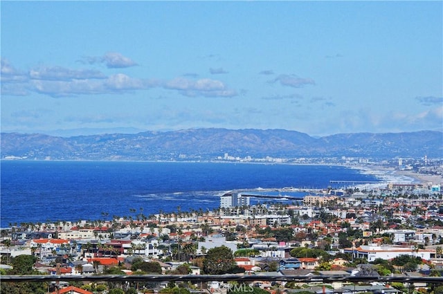 birds eye view of property with a water and mountain view