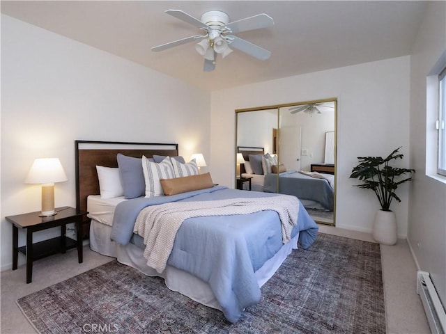 bedroom featuring carpet floors, baseboards, baseboard heating, and a closet