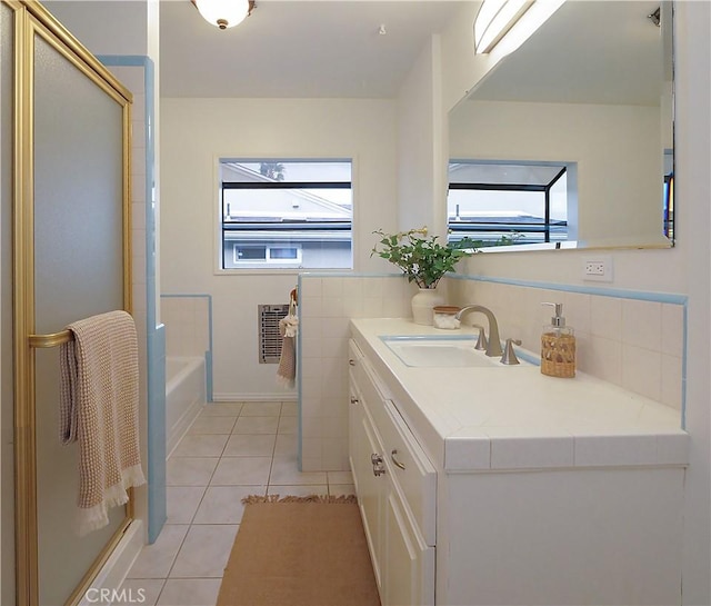 full bath featuring a wainscoted wall, tile walls, heating unit, vanity, and tile patterned floors