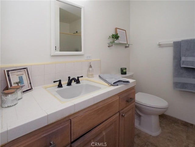 bathroom featuring tile patterned flooring, vanity, and toilet