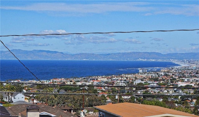 exterior space with a water and mountain view