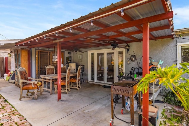 view of patio with outdoor dining area, french doors, and ceiling fan