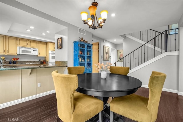 dining space featuring dark wood-type flooring, recessed lighting, visible vents, and stairs