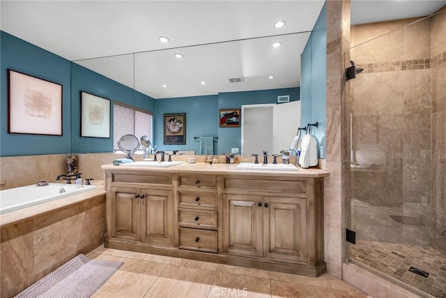 full bath with a stall shower, a garden tub, a sink, and double vanity