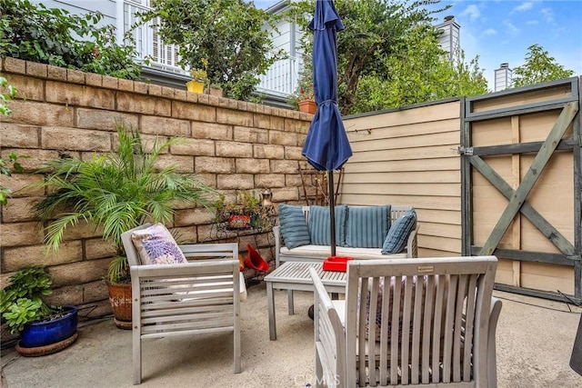 view of patio / terrace with fence and an outdoor living space