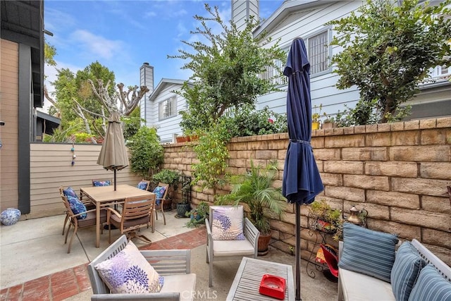 view of patio featuring fence and outdoor dining space