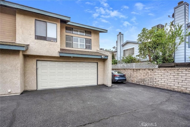 garage with aphalt driveway