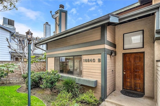 doorway to property featuring fence