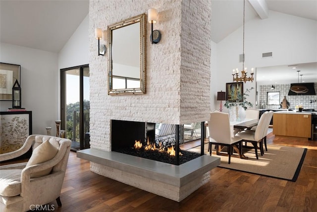 10831 Hideaway Dr, North Tustin, CA 92705 - living room with high vaulted ceiling, a notable chandelier, wood finished floors, and a fireplace