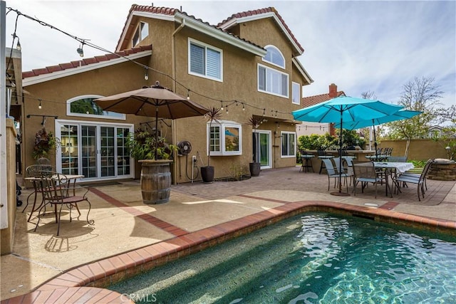 23 Landing, Laguna Niguel, CA 92677 - rear view of property featuring stucco siding, a patio area, an outdoor pool, and a tiled roof