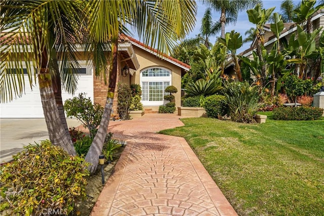 23 Landing, Laguna Niguel, CA 92677 - property entrance with stucco siding, a yard, a garage, and a tiled roof