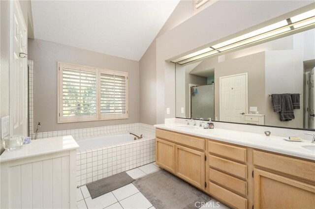 23 Landing, Laguna Niguel, CA 92677 - full bathroom featuring tile patterned floors, double vanity, a garden tub, and lofted ceiling