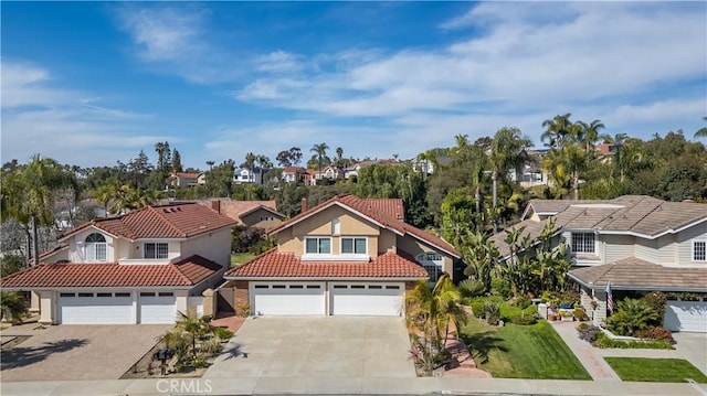 23 Landing, Laguna Niguel, CA 92677 - view of front facade featuring concrete driveway, a tiled roof, a residential view, stucco siding, and an attached garage