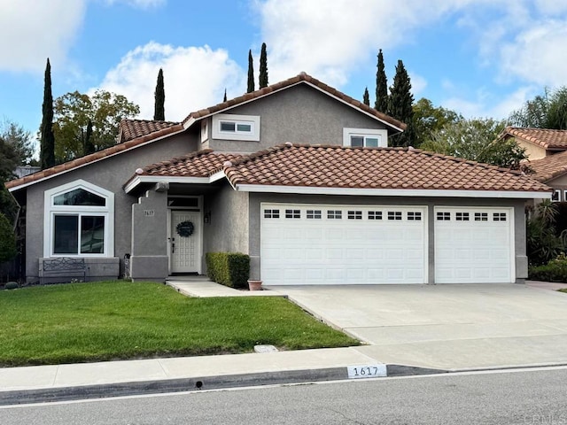 view of front of home with an attached garage, driveway, a tiled roof, stucco siding, and a front yard