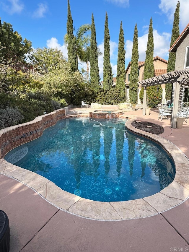 outdoor pool featuring a patio area, a pergola, and an in ground hot tub