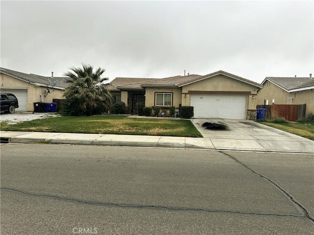 view of front of house with stucco siding, concrete driveway, an attached garage, a front yard, and cooling unit