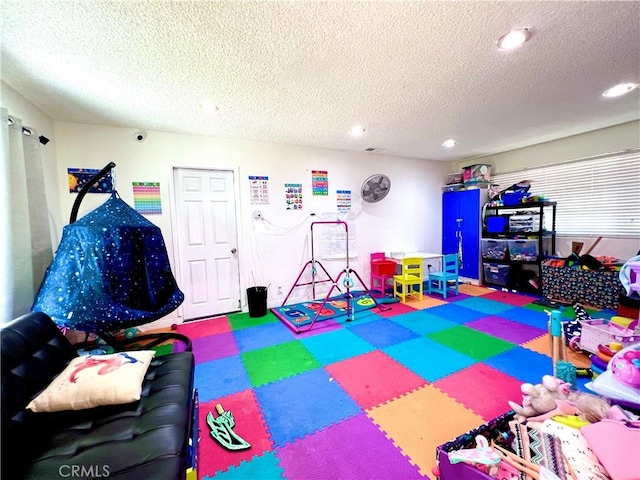 game room featuring a textured ceiling and recessed lighting