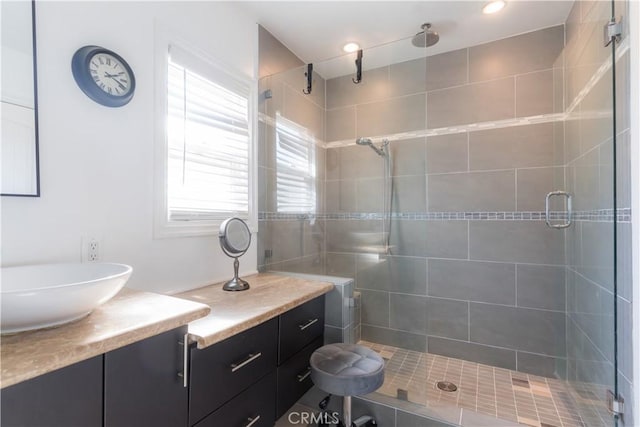 full bathroom with a stall shower and vanity