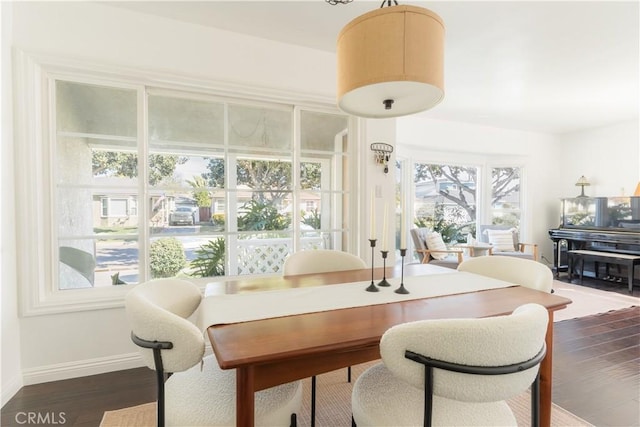 dining space with dark wood finished floors and baseboards