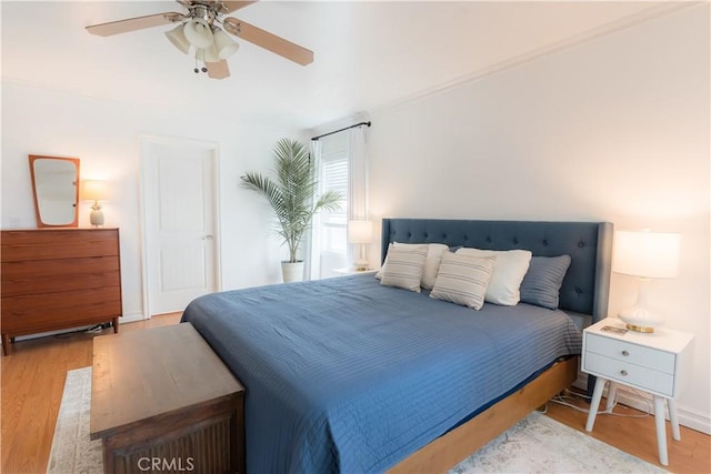 bedroom featuring a ceiling fan and wood finished floors