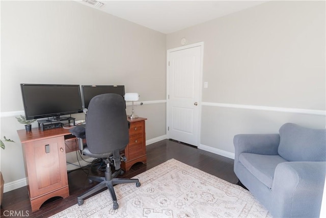 home office featuring visible vents, baseboards, and wood finished floors