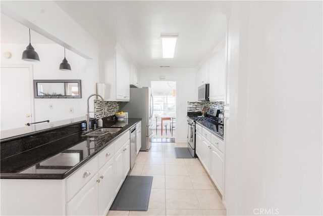 kitchen featuring stainless steel appliances, a sink, and white cabinetry