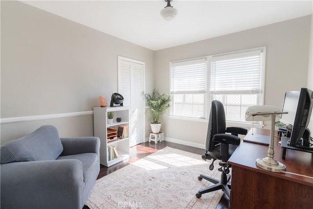 office featuring baseboards and wood finished floors