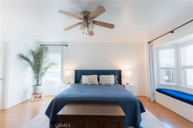 bedroom with light wood-style flooring and ceiling fan