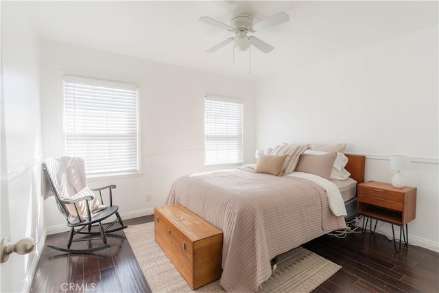 bedroom featuring ceiling fan, baseboards, and wood finished floors