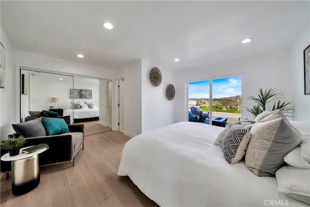 bedroom with access to exterior, light wood-type flooring, and recessed lighting