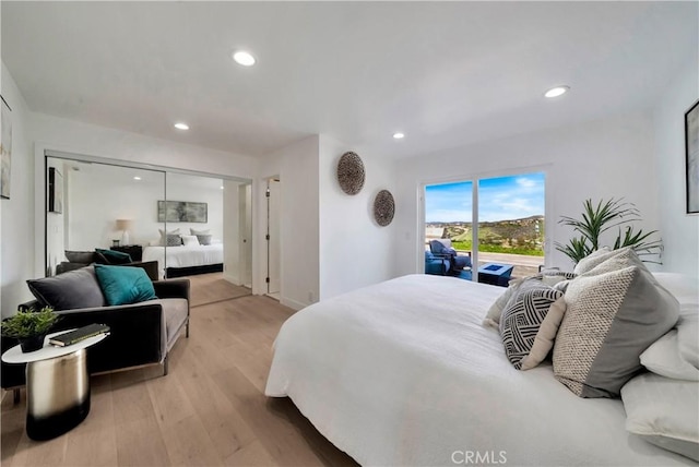 bedroom with access to outside, recessed lighting, and light wood-style flooring