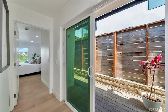 entryway with baseboards and light wood-style floors