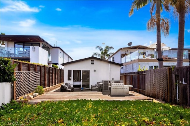 back of property featuring a yard, an outdoor living space, a fenced backyard, and stucco siding