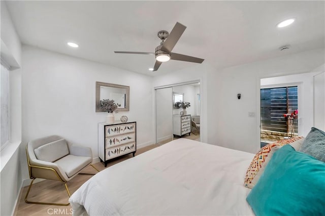 bedroom featuring a closet, wood finished floors, baseboards, ceiling fan, and recessed lighting