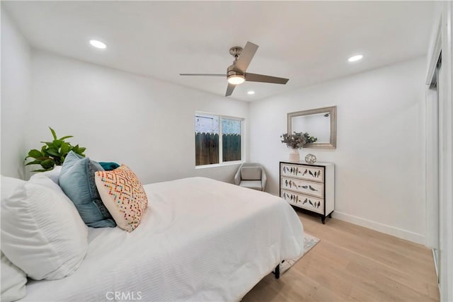 bedroom with baseboards, ceiling fan, light wood-style flooring, and recessed lighting