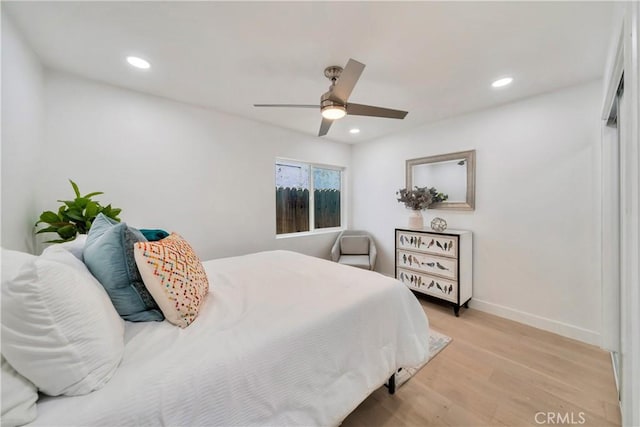 bedroom with recessed lighting, baseboards, ceiling fan, and light wood-type flooring