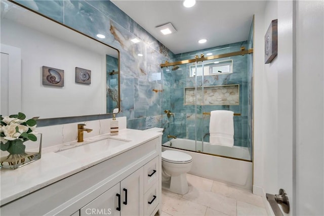 bathroom featuring toilet, recessed lighting, shower / bath combination with glass door, vanity, and tile walls