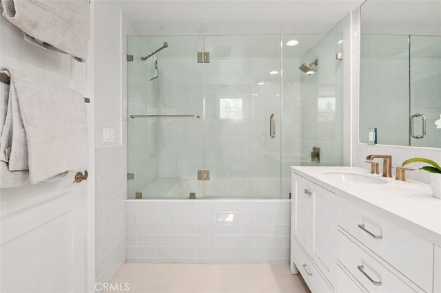 bathroom featuring tiled shower / bath combo, vanity, and tile patterned floors