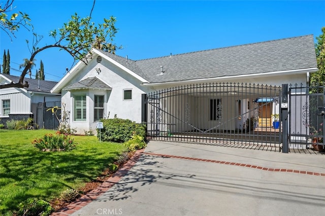 view of gate with fence and a yard