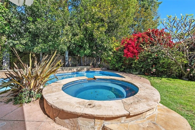 view of swimming pool with a fenced backyard, a lawn, and an in ground hot tub