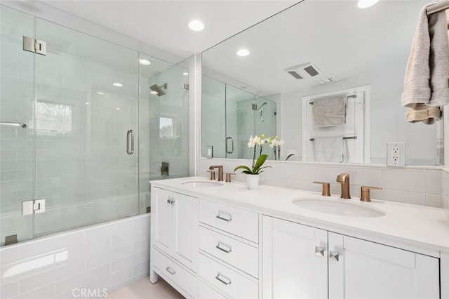 bathroom with double vanity, a sink, visible vents, and recessed lighting