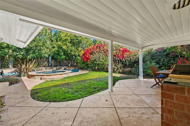 view of patio / terrace with an in ground hot tub and a fenced backyard