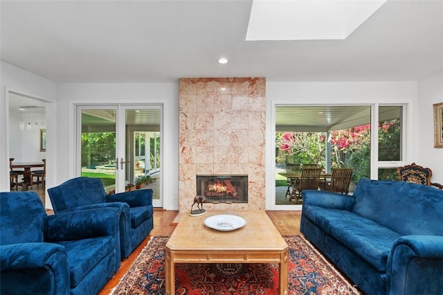 living room with recessed lighting, a fireplace, and wood finished floors