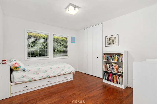 bedroom featuring a closet and wood finished floors