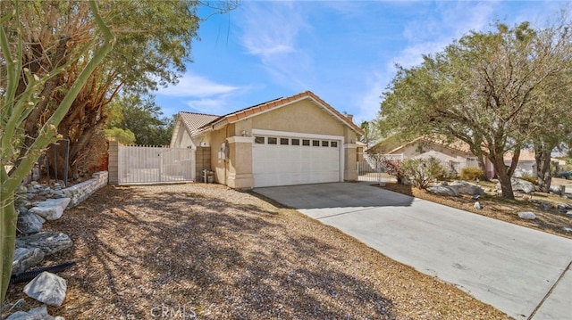 ranch-style house with a gate, fence, an attached garage, stucco siding, and concrete driveway